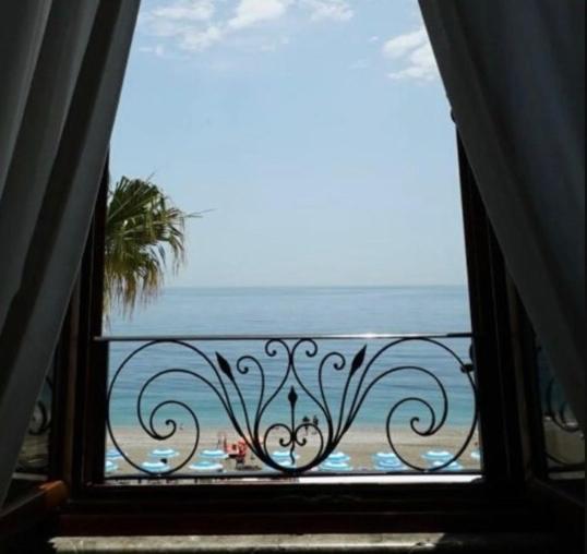 a view of the ocean from a balcony at Palazzo Durante in Letojanni