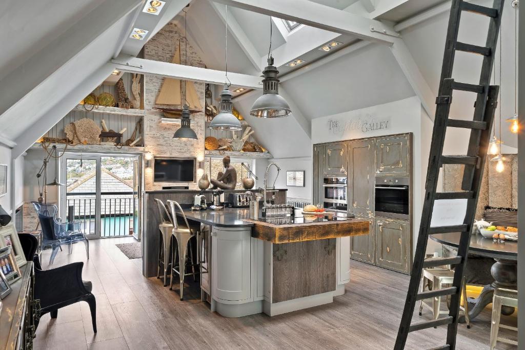 a kitchen with an island with a ladder at Finest Retreats - The Old Library in Dartmouth