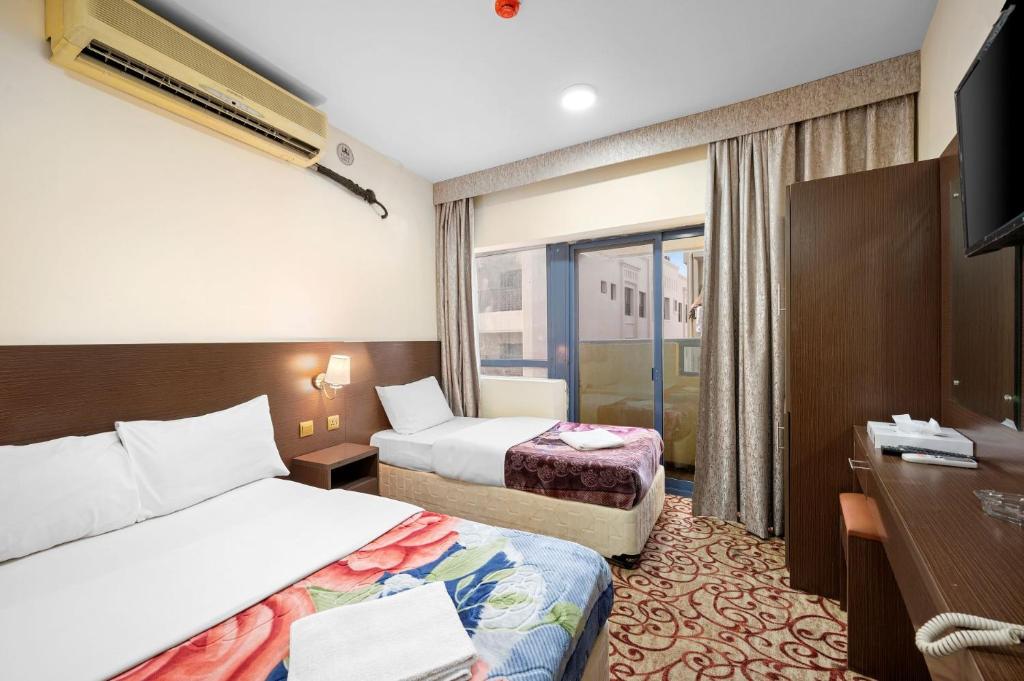 Postel nebo postele na pokoji v ubytování Najiba Hotel
