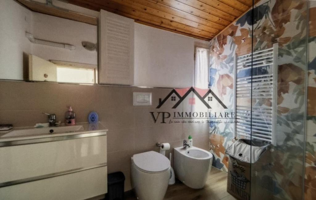 a bathroom with a toilet and a sink at Casa vacanza Pino in Follonica