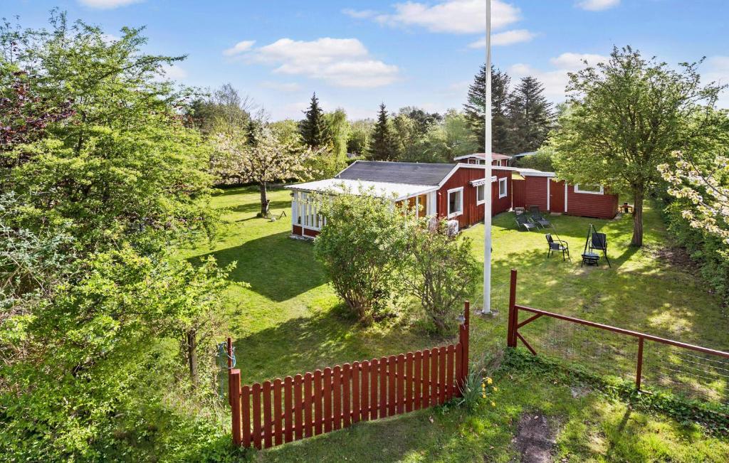 an aerial view of a red house with a fence at 3 Bedroom Cozy Home In Sjllands Odde in Tjørneholm