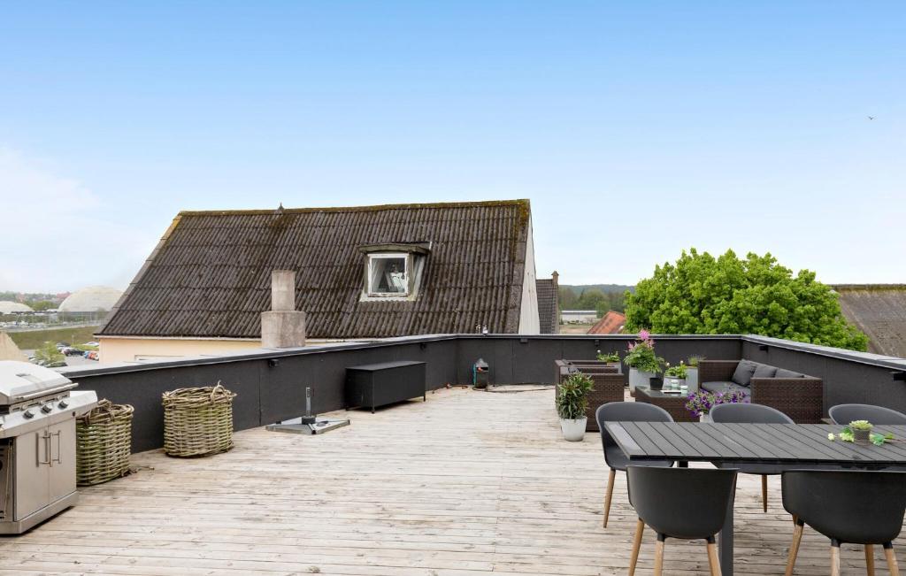 a patio with a table and chairs on a roof at Nice Apartment In Randers C With Wifi in Randers