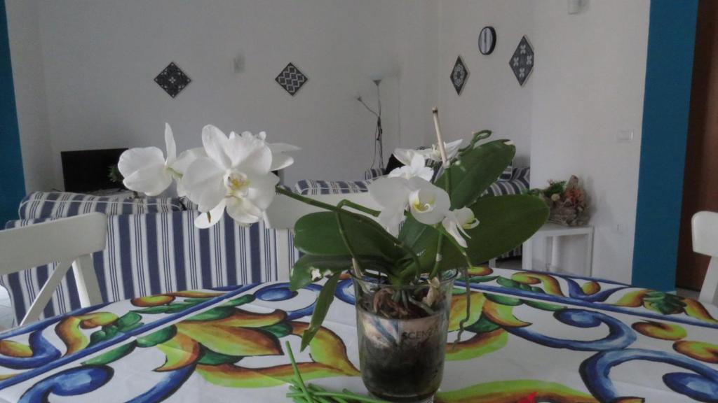 a vase with white flowers sitting on a table at BlueMind Freedom in Tropea