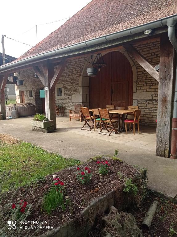 O' doubs saonois في Vallerois-le-Bois: فناء به طاولة وكراسي أمام مبنى
