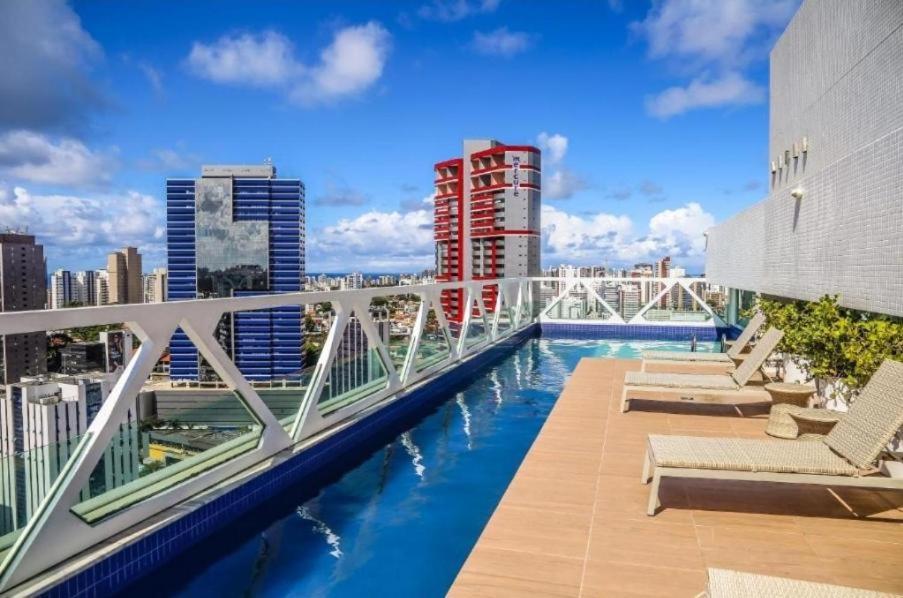 a swimming pool on the roof of a building at FLAT Salvador Business Corporation in Salvador
