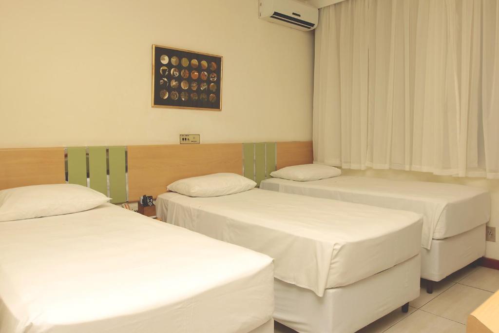 Postel nebo postele na pokoji v ubytování Sumatra Hotel e Centro de Convenções
