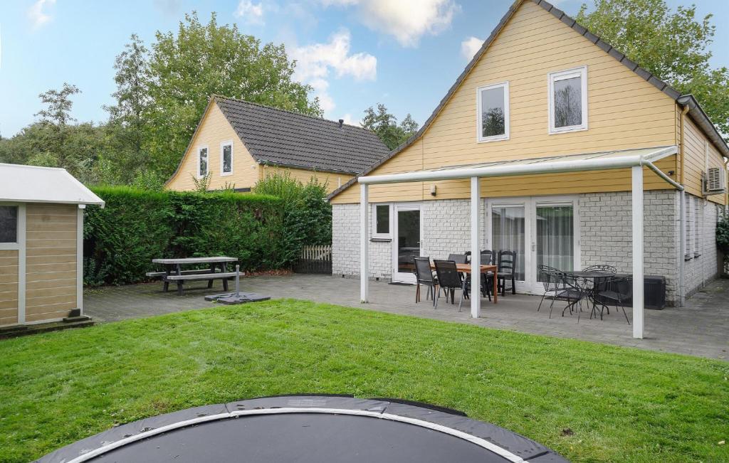 a house with a backyard with a trampoline at Beautiful Home In Wemeldinge With Wifi in Wemeldinge