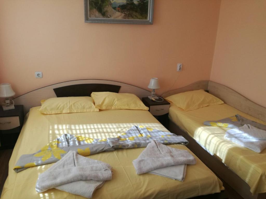 two beds sitting next to each other in a room at Вила Кичево in Varna City