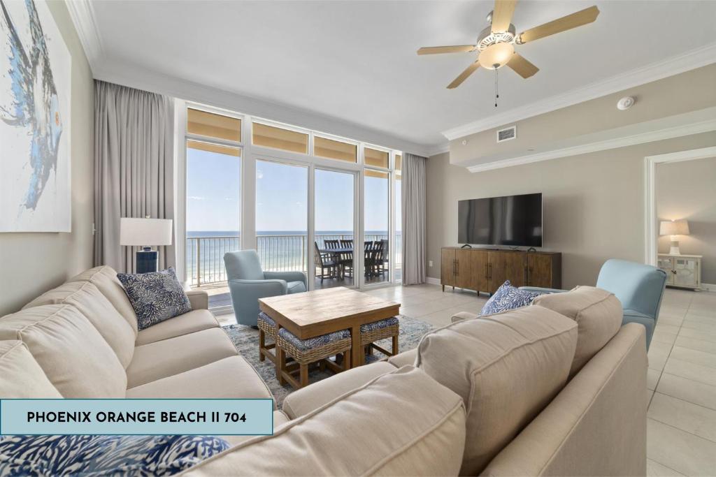 a living room with a couch and a table at Luxury Gulf Front Condo Lazy River 704 in Orange Beach