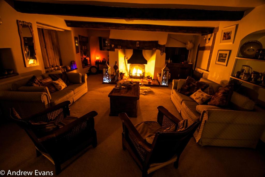 a living room with a couch and a fireplace at Lea House Bed and Breakfast in Ross on Wye