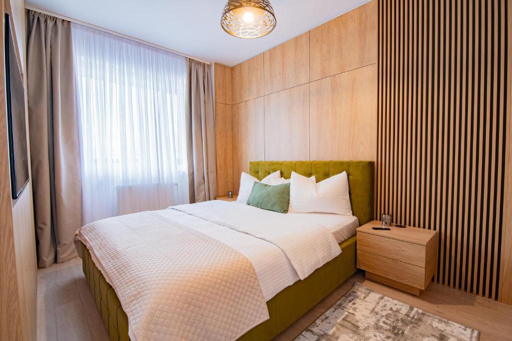 a bedroom with a large bed and a window at Denis Premium Suite - Private Parking - EV Station - Self Check-in in Oradea