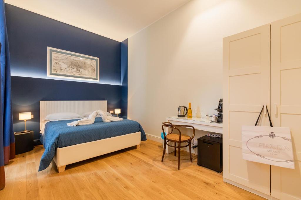 a small bedroom with a bed and a desk at Piazza San Domenico Luxury Suites in Naples