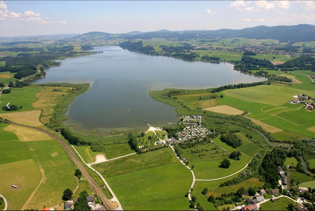 an aerial view of a lake in the countryside at Hotel Berg in Seekirchen am Wallersee