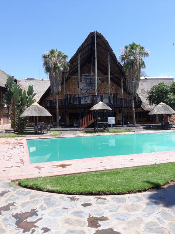 a swimming pool in front of a building at The Big Five Lodge in Gaborone