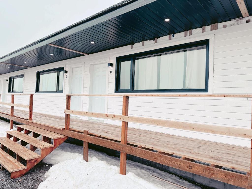 a white trailer with a black roof and windows at À Bon Port in Perce