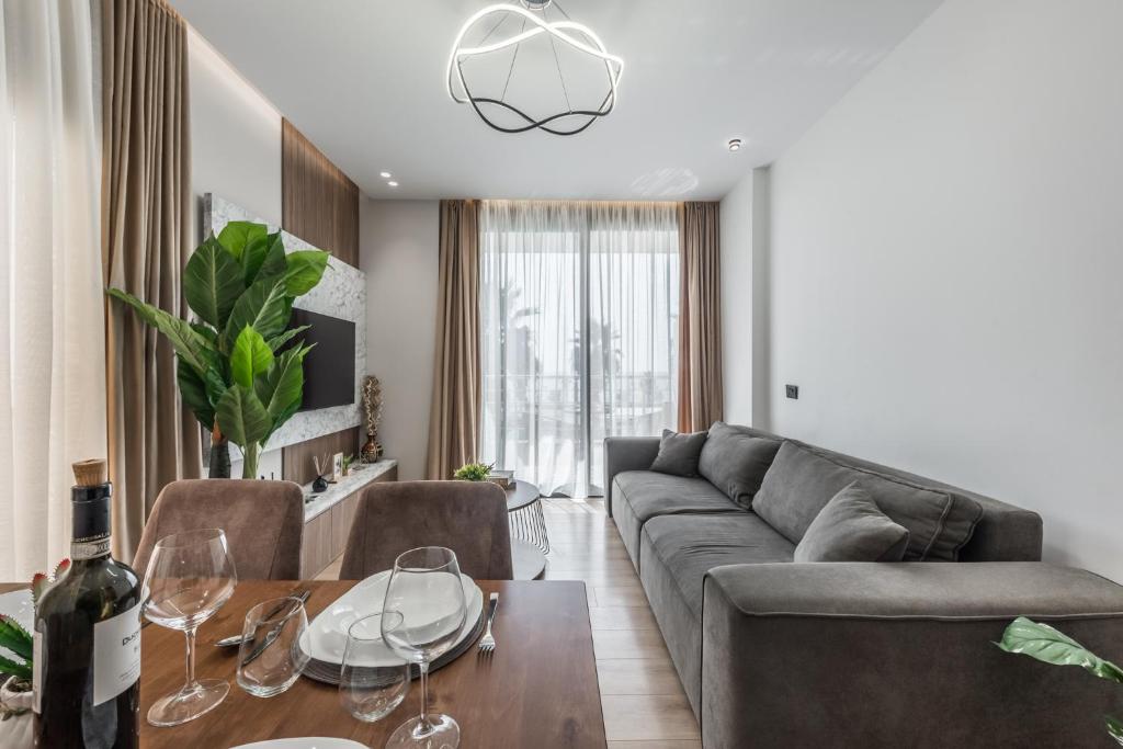 a living room with a couch and a table at Amazing beachfront Oasis in Durrës