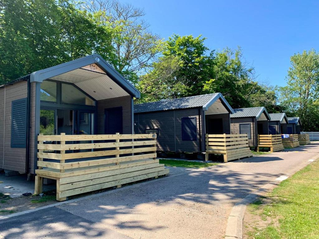 a row of camping cottages parked next to a road at Self-Catering Lodge with Hot Tub in Inverness