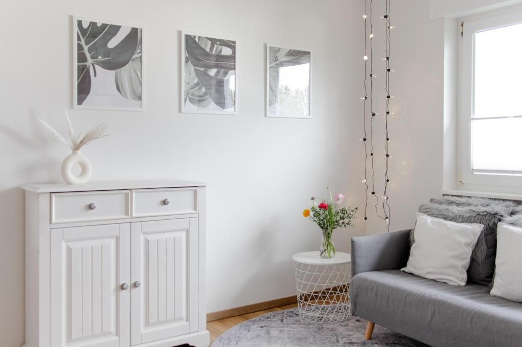 a living room with a couch and a cabinet at Ferienwohnung Parkblick in Bad Herrenalb