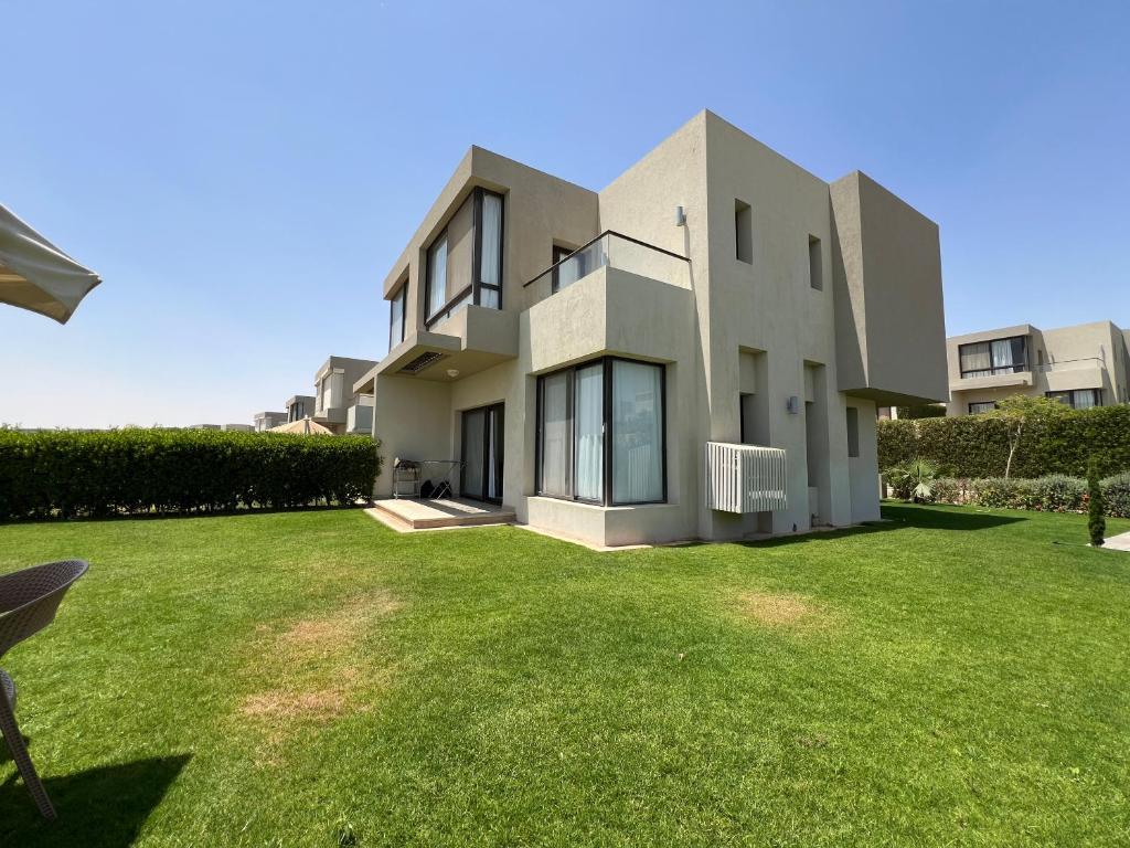 a house with a lawn in front of it at Azha Luxury vacation villa Ain sokhna - families only in Ain Sokhna