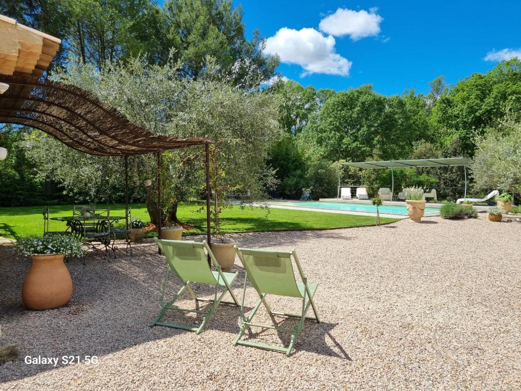 - deux chaises et un kiosque dans la cour dans l'établissement Escapade paisible au coeur du Luberon, à Grambois