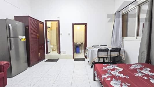 Zimmer mit Tischen und Stühlen sowie einem Kühlschrank in der Unterkunft GMR House in Irbid