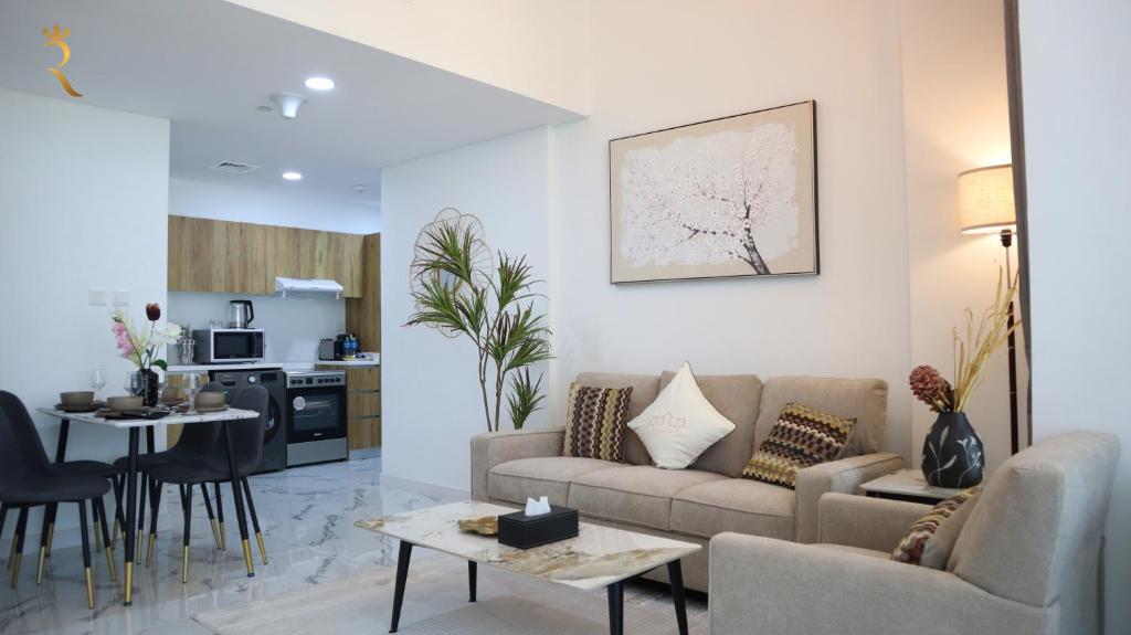 a living room with a couch and a table at Lavish 2BR Duplex in Masdar City - Luxe Retreat Near Masdar Park & City Centre in Abu Dhabi