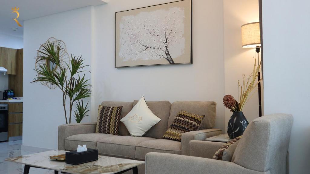 a living room with a couch and a table at Opulent 2BR Duplex Apartment in Abu Dhabi