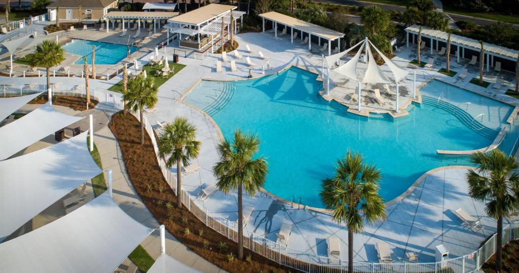 an overhead view of a large swimming pool with palm trees at 1316 Pelican Watch Villas Seabrook Island SC in Seabrook Island