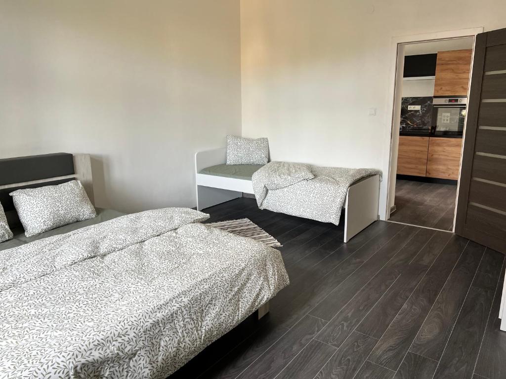 a bedroom with two beds and a desk and a chair at Rezidence Bratrská in Ostrava