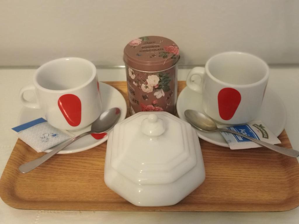a wooden tray with two cups and a tea pot at Casa coqueta con jardin in La Redondela
