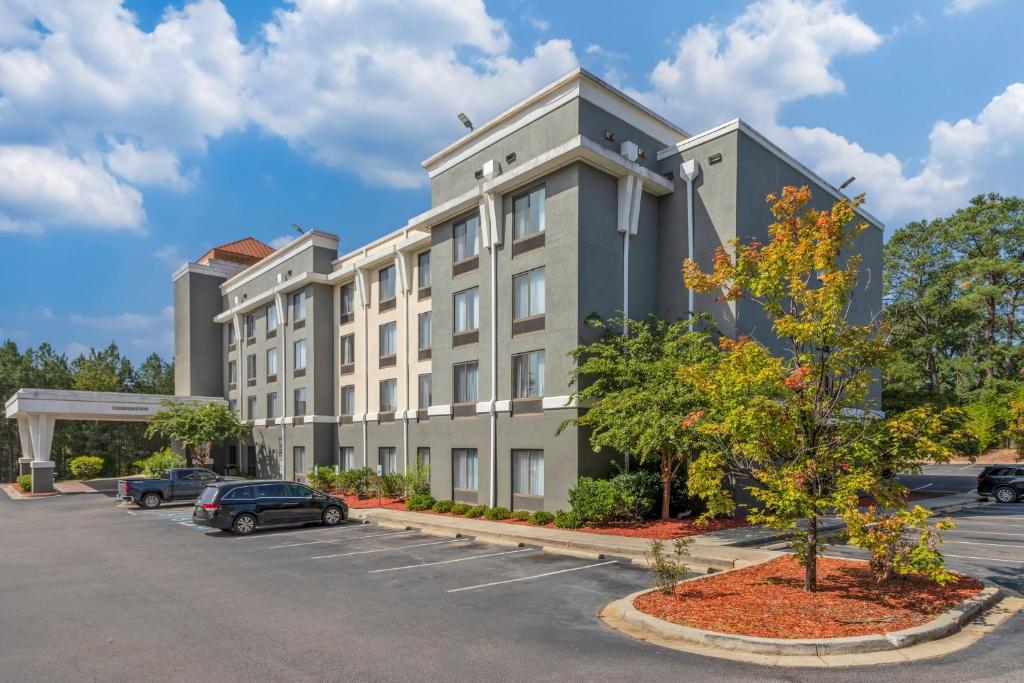 a large building with cars parked in a parking lot at Comfort Suites Columbia Northeast - Fort Jackson in Columbia