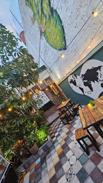 a restaurant with a table and chairs and plants at Casa Columpio in Mexico City