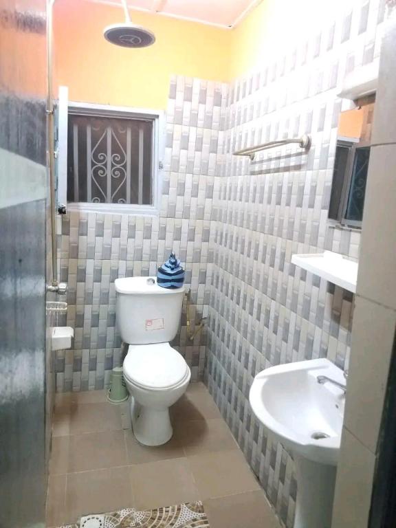 a bathroom with a toilet and a sink at As résidence meubles E p in Ouagadougou