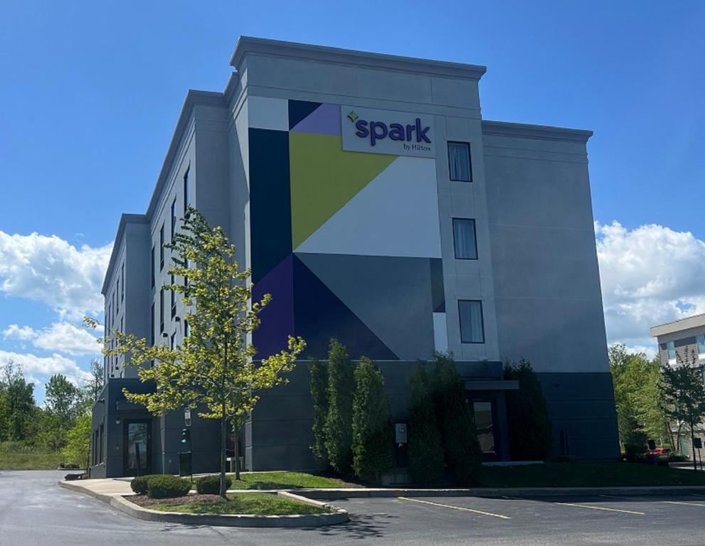 a building with a sign on the side of it at Spark by Hilton Erie in Erie