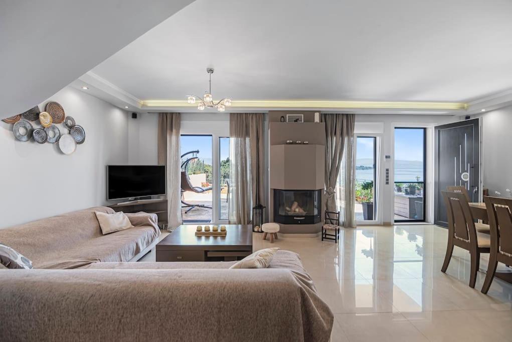 a living room with a couch and a fireplace at Anastasia maisonette sea view in Kontokali
