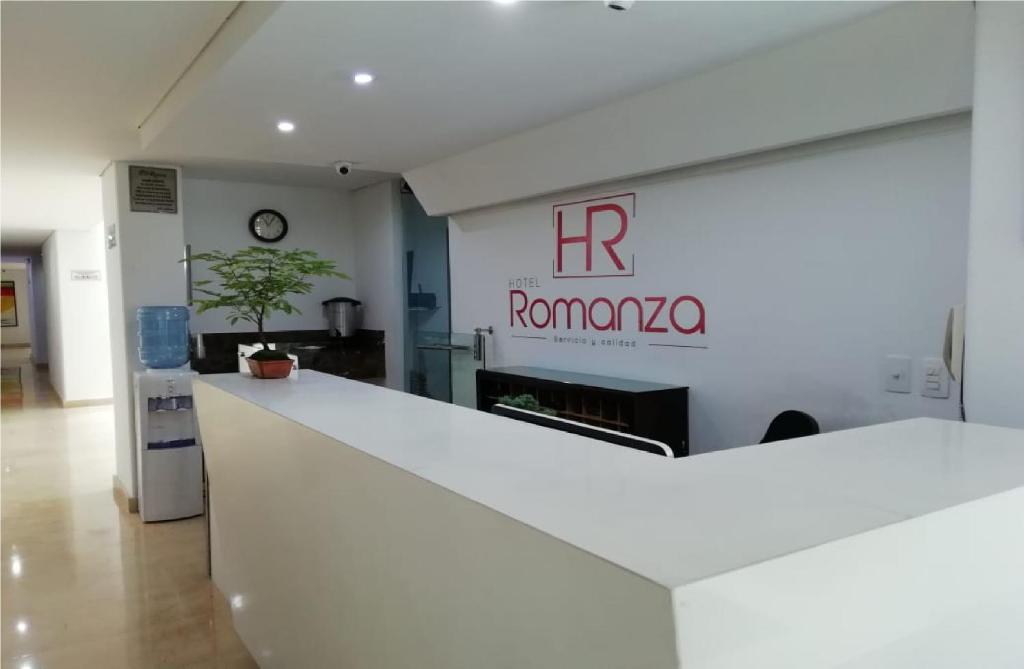 a white counter in a room with a sign at Hotel Romanza in Medellín