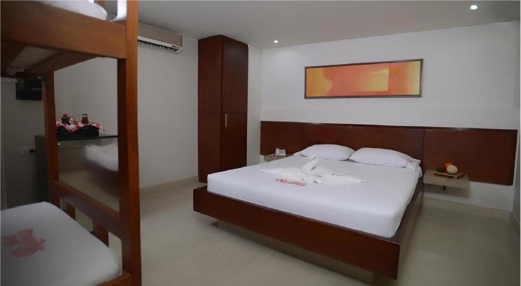 Postel nebo postele na pokoji v ubytování Hotel Romanza