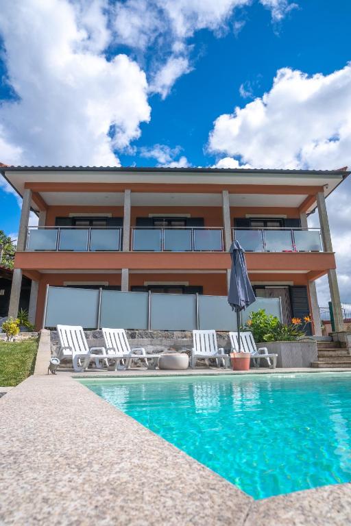 a villa with a swimming pool and a house at CASA DA ROSARINHO - Casa de Férias com Piscina - Arcos de Valdevez in Arcos de Valdevez