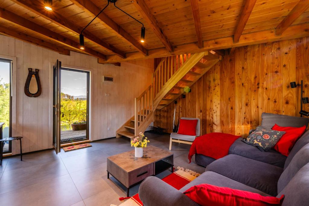 a living room with a couch and a table at Domek Trohaniec in Lutowiska