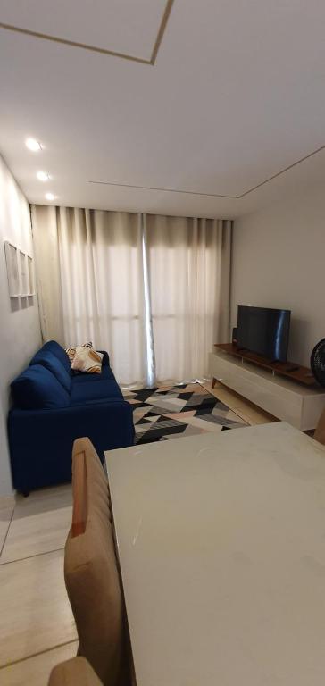 a room with a bed and a couch and a table at Xodó da Aldeia in São Pedro da Aldeia