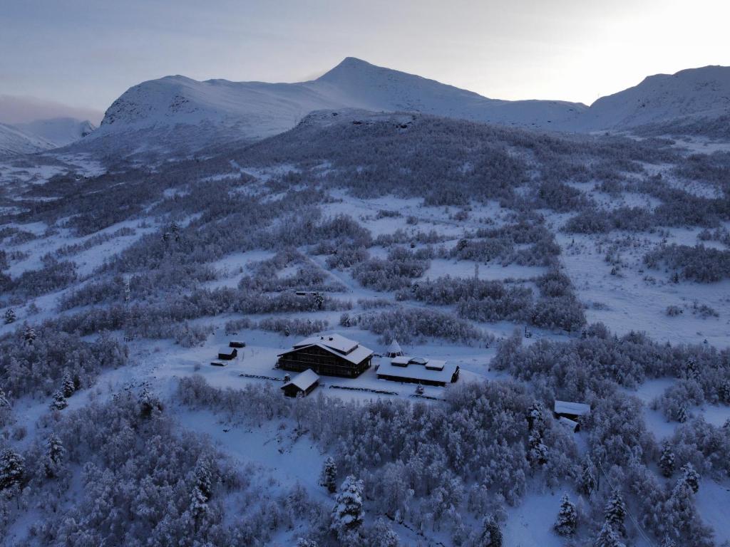 an aerial view of a house on a snowy mountain at Blåtind Boutique Hotel in Stordal