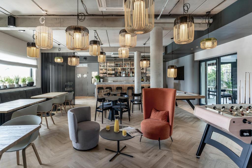 restauracja ze stołami i krzesłami oraz bar w obiekcie Rosa Style w Rowach