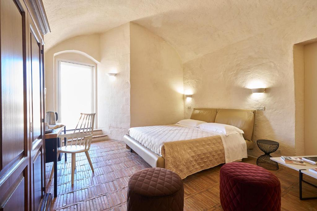 Una cama o camas en una habitación de Fra I Sassi Residence