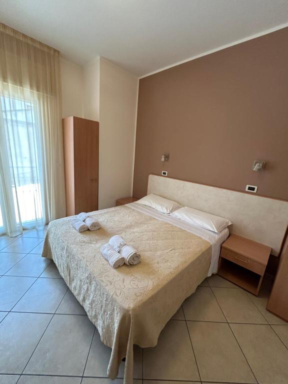 Postel nebo postele na pokoji v ubytování Hotel Favorita