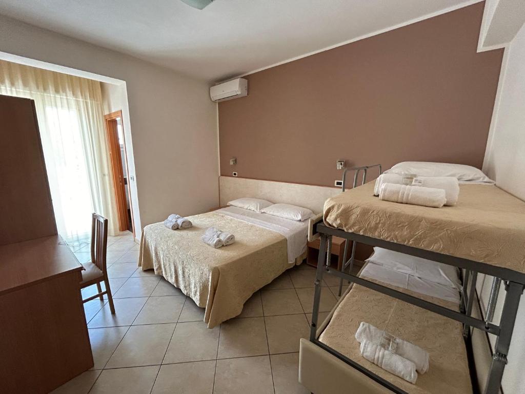 Postel nebo postele na pokoji v ubytování Hotel Favorita