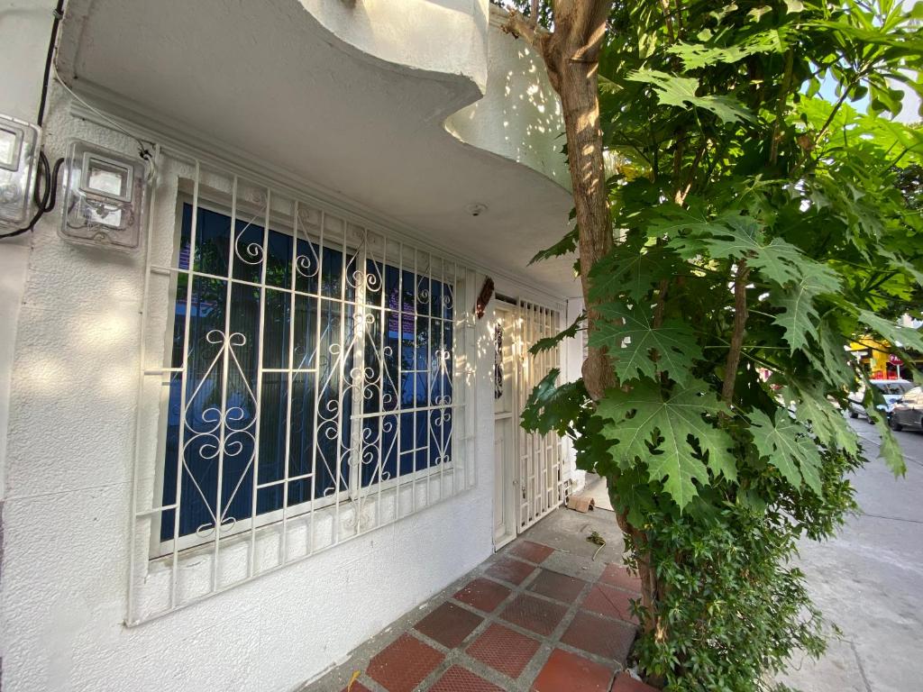 a door with a blue gate on a building at Casa Mi Valle Loft in Santa Marta