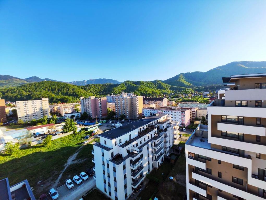 an aerial view of a city with mountains in the background at Mountain Breeze ApartTerrace in Braşov