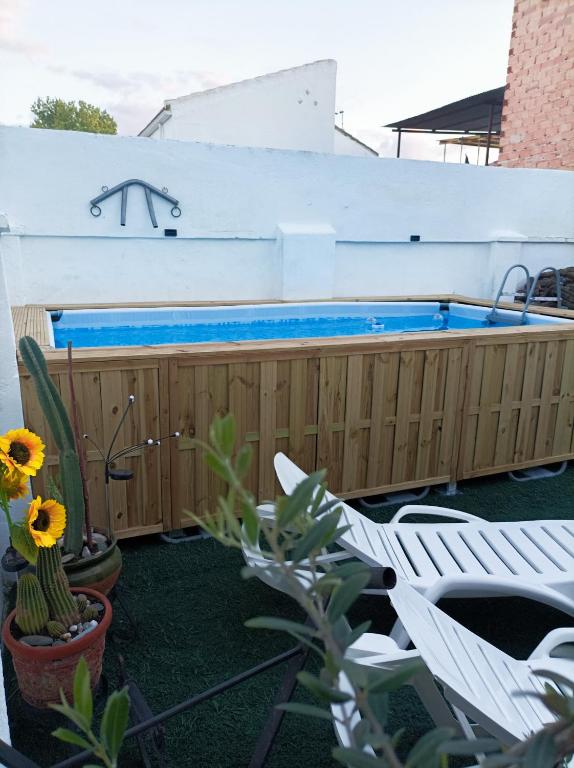 a swimming pool on the side of a house at Casa Jienense in Campillo del Río