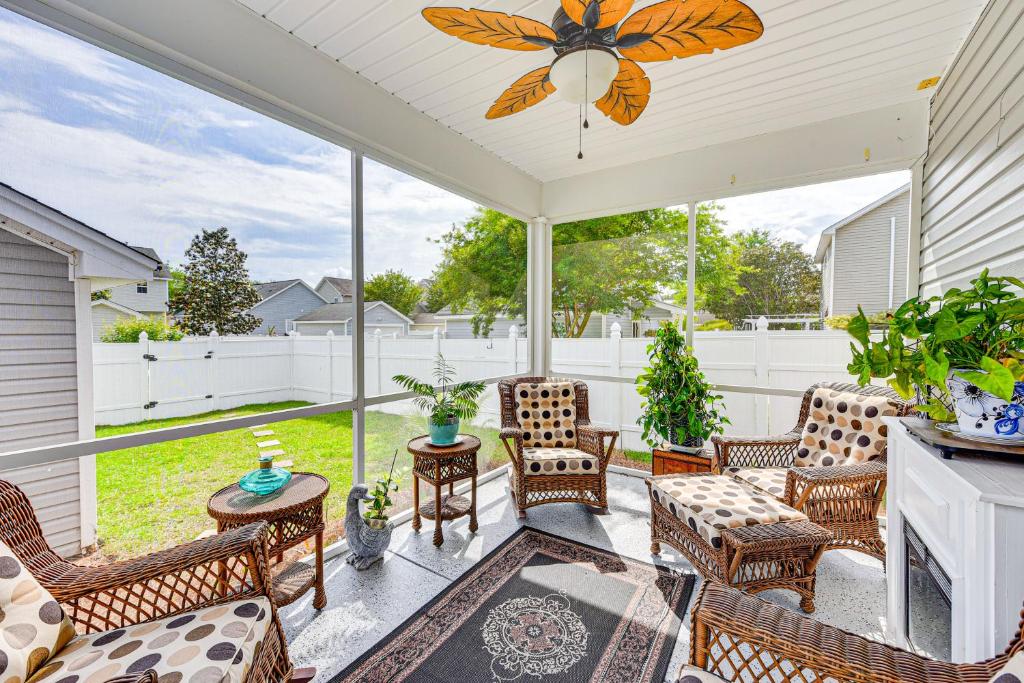 a screened in porch with chairs and a table at Charming Bluffton Home with Yard about 3 Mi to Beaches! in Bluffton