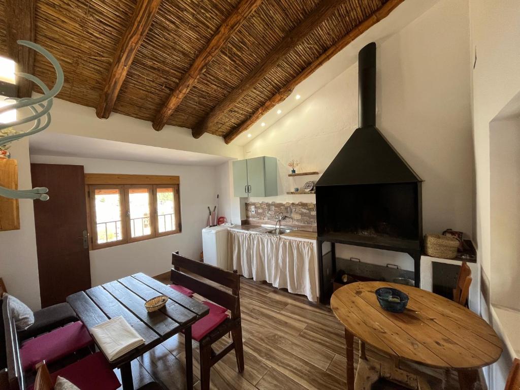 a living room with a table and a fireplace at Casa abuelo Motilla in Alcalá del Júcar